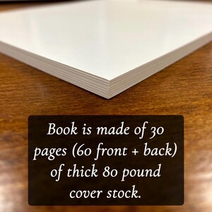 May include: Close-up of the edge of a book showing the thick, white paper stock. The text reads: "Book is made of 30 pages (60 front + back) of thick 80 pound cover stock."