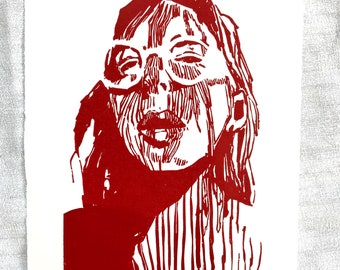 Original handmade linoleum printing, DIN A4. Limited, numbered and signed. Woman with glasses, shadow, red.