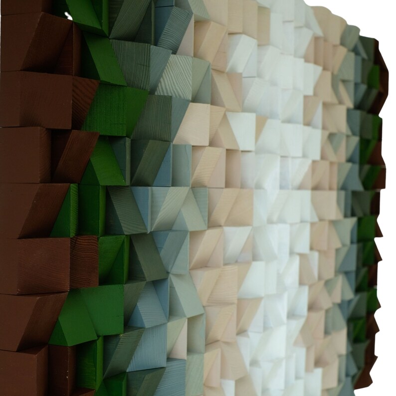 May include: A wall art piece made of wooden blocks in various shades of brown, green, blue, beige, and white. The blocks are arranged in a geometric pattern, creating a visually interesting and textured surface.