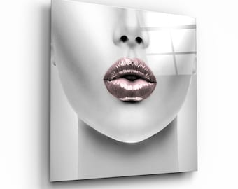 May include: A close-up of a woman's face with a black and white background. The woman's lips are painted a glossy pink color.