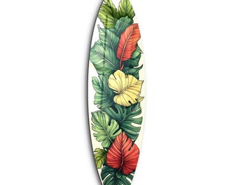 Op de afbeelding: Een wit surfplank met een tropisch bladontwerp. De bladeren zijn groen, geel en rood.
