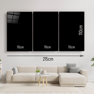 May include: Three black framed wall art pieces, each measuring 70cm wide and 110cm tall, arranged horizontally on a white wall. The total width of the three pieces is 215cm.