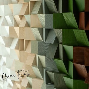 May include: A wall art piece made of wood blocks in various shades of green, brown, and beige. The blocks are arranged in a geometric pattern, creating a visually interesting and textured surface. The text "Green Earth" is visible in the lower left corner of the image.