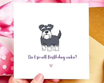 Puede incluir: Tarjeta de felicitación blanca con un perro Schnauzer de dibujos animados en blanco y negro. El texto "Do I smell Birthday cake?" es morado, con un pequeño corazón rosa debajo.