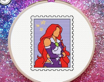 May include: A cross-stitch embroidery in a circular wooden hoop featuring a postage stamp design. The stamp depicts a stylized figure with long red hair, wearing a purple and white outfit with a green gem, set against a light purple background.
