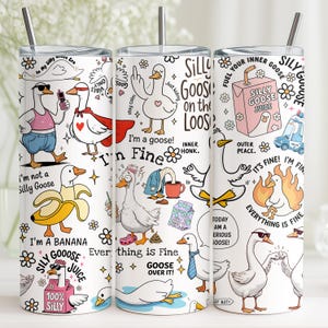 May include: A white stainless steel tumbler featuring cartoon geese with sunglasses and various phrases like "Silly Goose Juice" and "Everything is Fine." The tumbler includes a silver straw and a black lid. The design is whimsical and colorful.