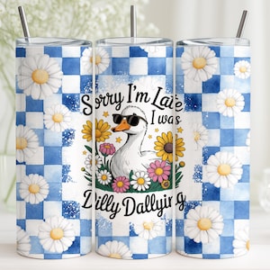 May include: A stainless steel tumbler with a blue and white checkered pattern and daisy accents. The tumbler features a cartoon duck wearing sunglasses, surrounded by flowers, and the text "Sorry I'm Late I Was Dilly Dallying."
