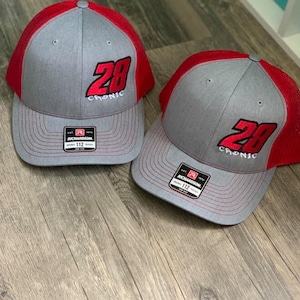May include: Two gray and red trucker hats with a black embroidered number 28 and the word "Chronic" on the front.