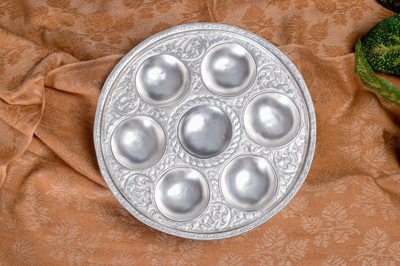 May include: A silver Seder plate with six indentations for holding the traditional foods for the Passover Seder meal.