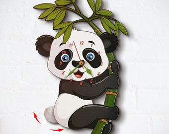 May include: A black and white panda bear clock with a green bamboo stem. The panda is holding onto the bamboo stem with its paws. The clock face has black numbers and hands.