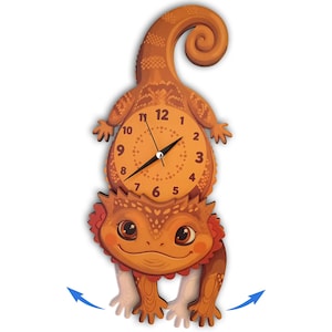 May include: A wall clock shaped like an orange bearded dragon with a curled tail. The clock face is positioned on the lizard's back, featuring black numbers from 1 to 12 and black hands. The lizard has large eyes and a red frill around its neck.