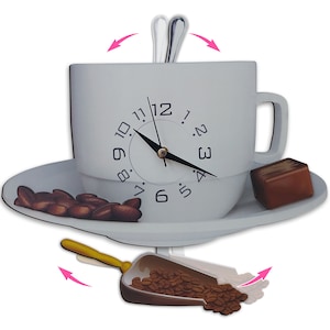 May include: A white coffee cup and saucer clock with a pendulum shaped like a coffee scoop filled with coffee beans. The clock face has black numbers and hands. A small chocolate bar is on the saucer.