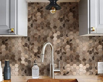 May include: A kitchen scene featuring a stainless steel faucet, a sink, and a backsplash of hexagonal tiles in shades of brown and bronze. A black light fixture hangs from the ceiling. Gray cabinets with gold hardware are visible.