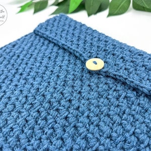 May include: A blue crocheted pouch with a wooden button closure.
