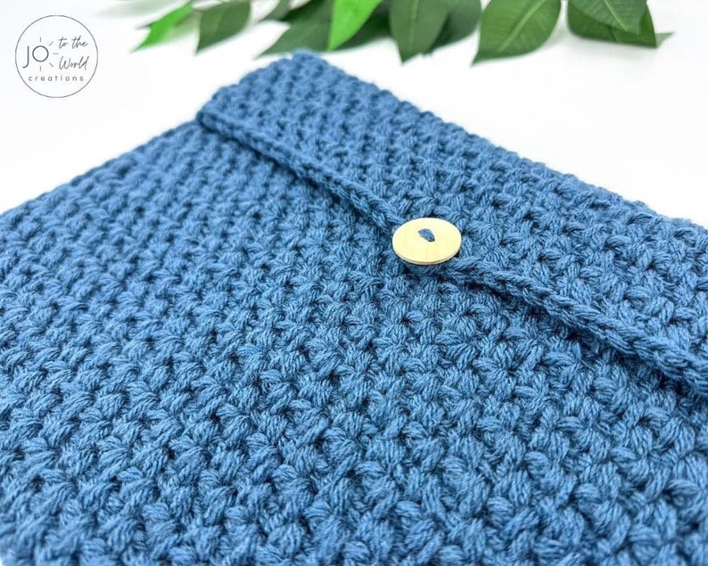 May include: A blue crocheted pouch with a wooden button closure.