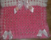 Pink and white pom pom blanket