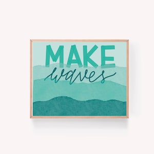 May include: A framed print with a teal blue watercolour background and the text "MAKE waves" in a dark teal blue font.