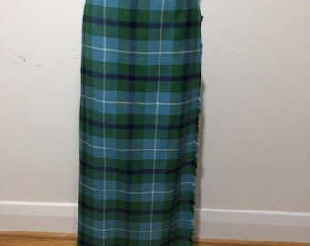 Vintage long maxi wool kilt. Skirt is blue and green tartan with black leather straps. Fringe with a Velcro closure. Wonderful!