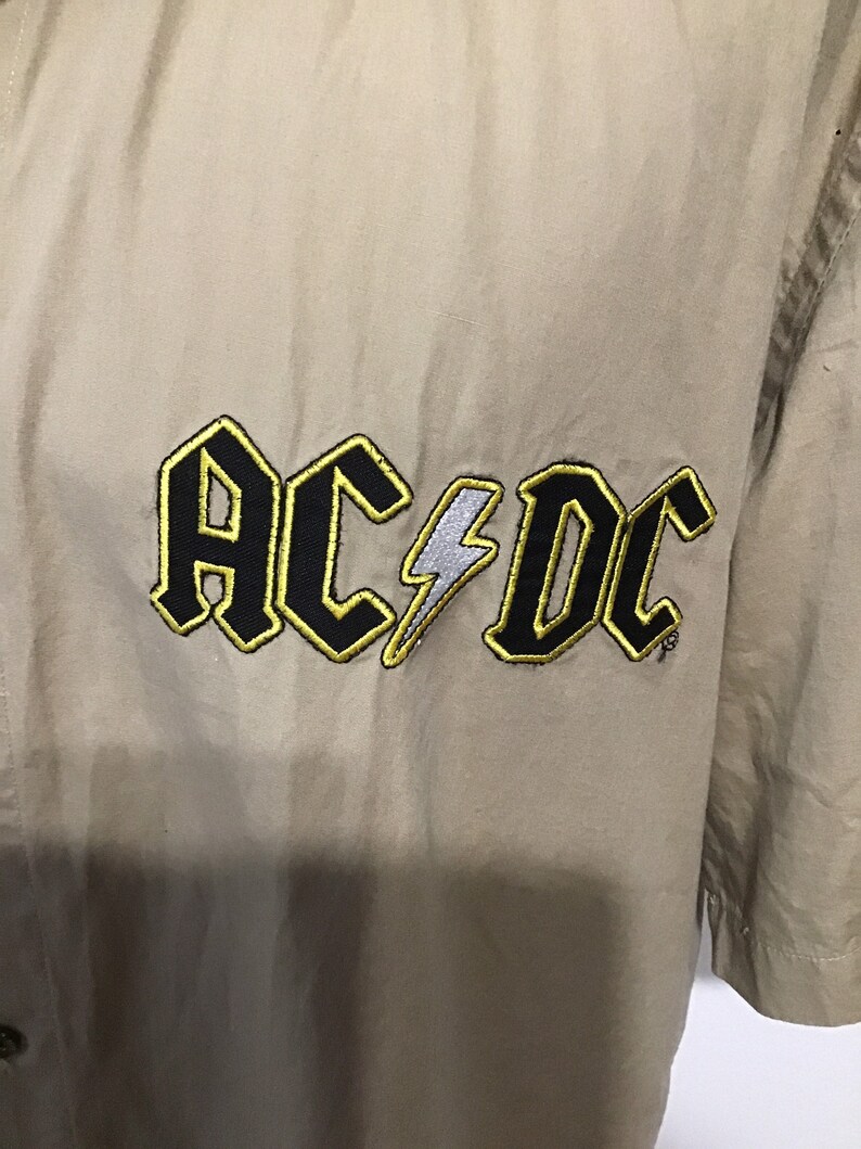 Gold outlining letters AC DC Rockware cotton beige shirt Licensed Made in USA