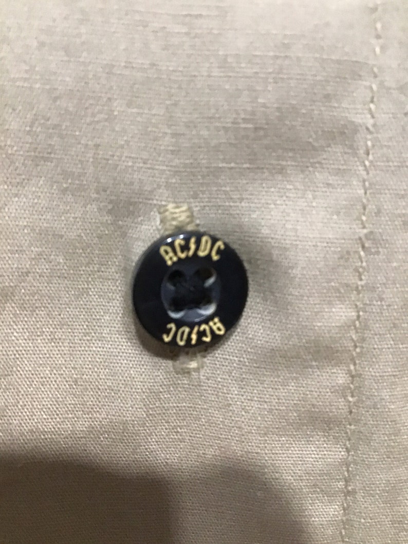 Gold outlining letters AC DC Rockware cotton beige shirt Licensed Made in USA