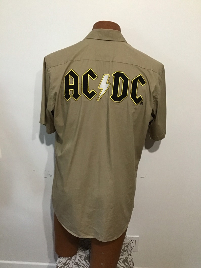 Gold outlining letters AC DC Rockware cotton beige shirt Licensed Made in USA