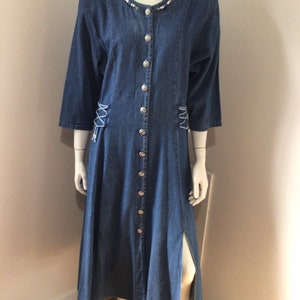 80s Lightweight denim flared dress. Raglan sleeves, shoulder pads, corset ties at waist, beaded around neckline, size 15-16.