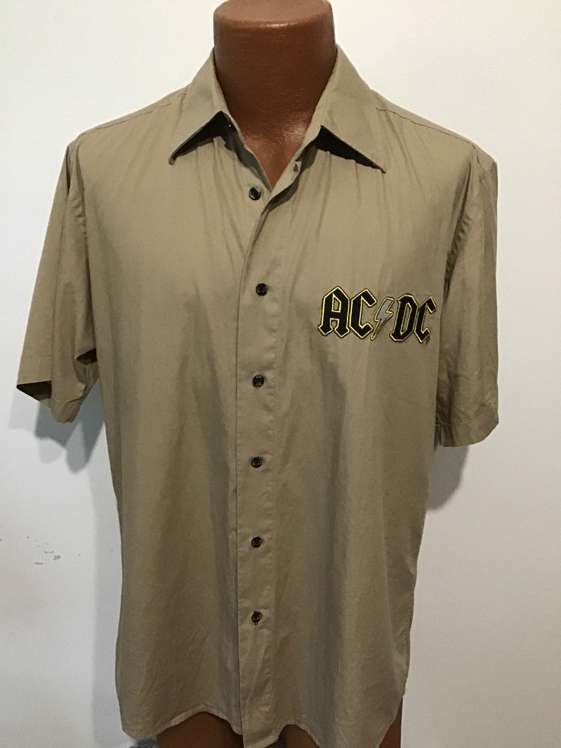 Gold outlining letters AC DC Rockware cotton beige shirt Licensed Made in USA