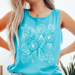 May include: A turquoise tank top with a white graphic of various seashells and a starfish. The text "Lagoon" is printed on the bottom of the shirt.