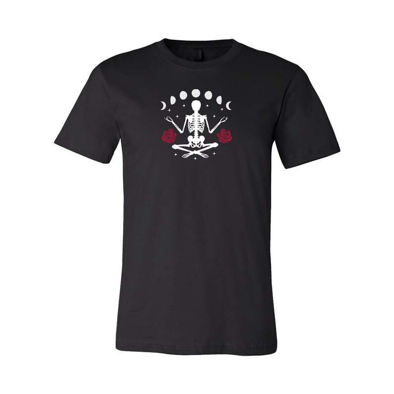 May include: Black t-shirt with a white skeleton meditating with a crescent moon and stars above and red roses on either side.