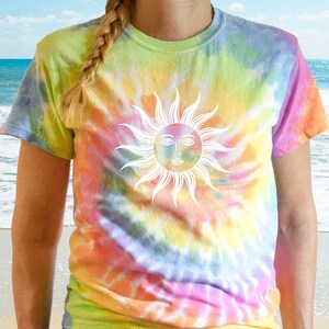 May include: A tie-dye t-shirt with a vibrant rainbow pattern of yellow, green, orange, and pink. The shirt features a white sun graphic with a face. The short-sleeved tee is a casual, colorful garment.