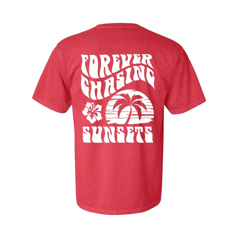 May include: Red t-shirt with a white graphic design that says "FOREVER CHASING SUNSETS" with a palm tree and hibiscus flower.