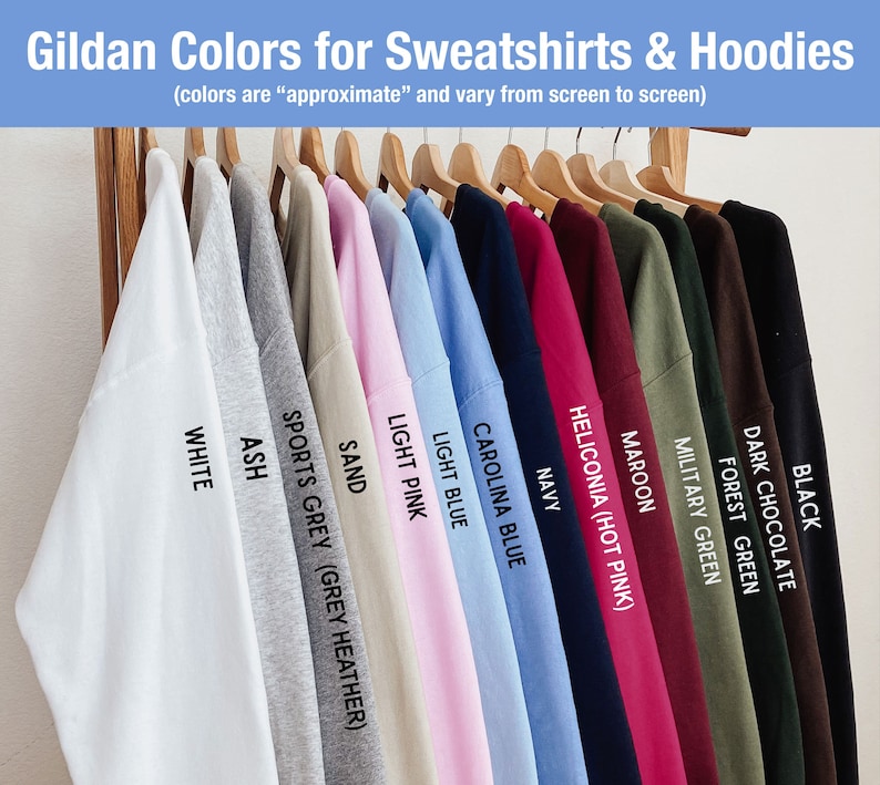 K&ouml;nnte beinhalten: Eine Reihe von Gildan-Sweatshirts und Hoodies in verschiedenen Farben, darunter Wei&szlig;, Asche, Sportgrau, Sand, Hellrosa, Hellblau, Carolina-Blau, Marine, Heliconia (Pink), Rotbraun, Milit&auml;rgr&uuml;n, Waldgr&uuml;n, Dunkelbraun und Schwarz.