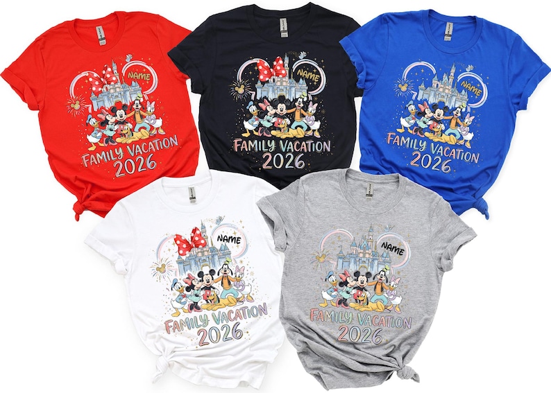 May include: Five short-sleeved t-shirts in red, black, blue, white, and gray. Each features a graphic of cartoon characters in front of a castle with fireworks, the text "NAME", "FAMILY VACATION", and "2026" printed in a colorful, stylized font.