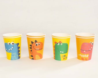 May include: Four yellow paper cups with dinosaur designs. The cups feature different dinosaurs with phrases like "Mr. Wild Boy", "Cool Dude", and "Roar".