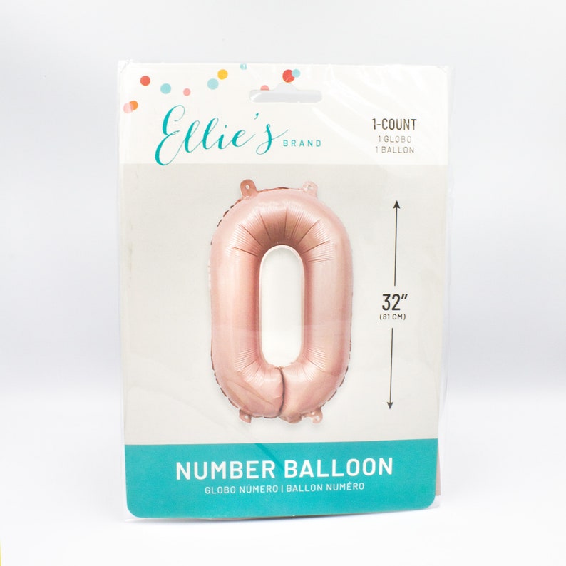 May include: Rose gold number 0 balloon, 32 inches (81 cm) in size.  The balloon is packaged in a clear plastic bag with a white and pink label that says "Ellie's Brand" and "Number Balloon".