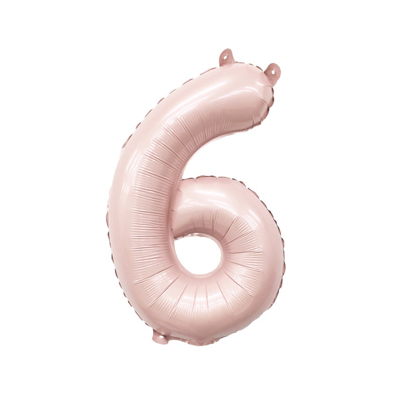 May include: A large, rose gold colored, foil balloon shaped like the number six.