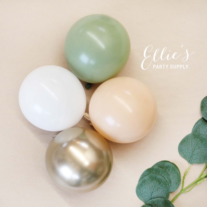 May include: Four balloons in a neutral color palette: sage green, white, beige, and gold. The balloons are arranged in a cluster on a light brown background.  Ellie's Party Supply is printed in white text on the background.