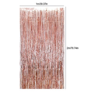 May include: Rose gold foil fringe curtain, 78.74 inches long and 39.37 inches wide. The curtain is made of thin strips of foil that hang down from a horizontal bar.