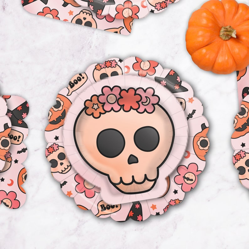 May include: Pink paper plates with a skull design and floral accents. The plates feature the words "Boo!" and "Bow!" in a speech bubble.