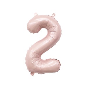 May include: A large, pink, metallic number two balloon. The balloon is inflated and ready to be used for a party or celebration.