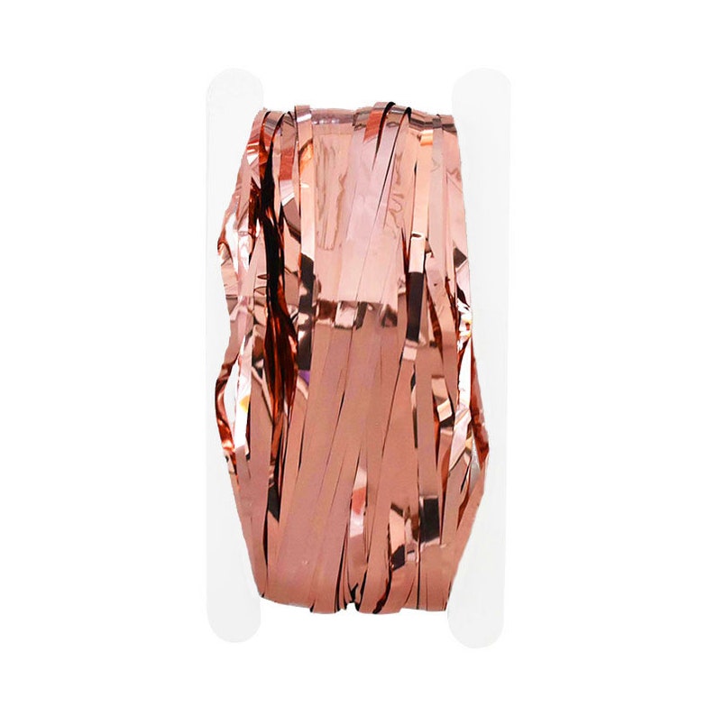 May include: A roll of rose gold metallic streamer for party decorations. The streamer is made of thin, shiny strips of foil.