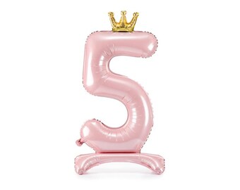 May include: A pink number 5 balloon with a gold crown on top. The balloon is designed to stand upright, perfect for a birthday celebration. The balloon is made of a shiny material and has a stand at the bottom.