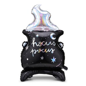 May include: A black cauldron balloon with a silver iridescent flame on top. The cauldron has a crescent moon and stars on it and says "hocus pocus" in rainbow lettering.