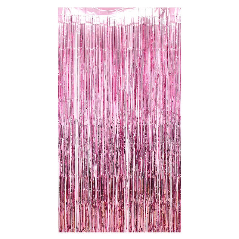 May include: A pink metallic fringe curtain. The curtain is made of long, vertical strips of shiny material, creating a shimmering effect. The colour is a vibrant, medium pink, suitable for party decorations or photo backdrops.
