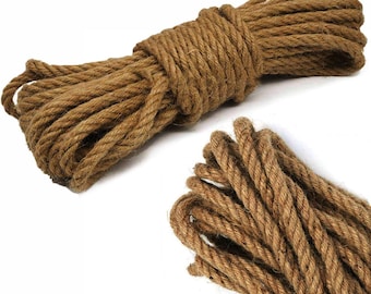 May include: A close-up of a thick, natural brown jute rope. The rope is coiled and twisted, showing its texture and natural fibers.