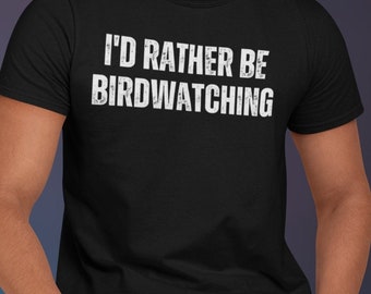 May include: A black t-shirt with the text "I'd rather be birdwatching" in white lettering.