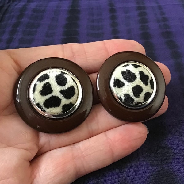 Large plastic round clip on earrings with a material leopard print centre.