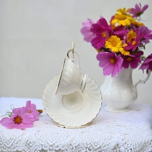 Beautiful! Royal Bone China Tea Cup and saucer, white with gold.