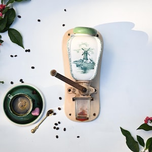 Antique coffee grinder Zassenhaus, ceramic, wall mounted, with metal handle, with white and green.