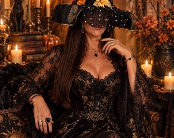 May include: A black pointed hat with gold lace, floral accents, and a black lace veil. The outfit includes a black corset with gold embroidery, a matching lace-trimmed long-sleeved top, and a velvet skirt with gold floral patterns and a belt.